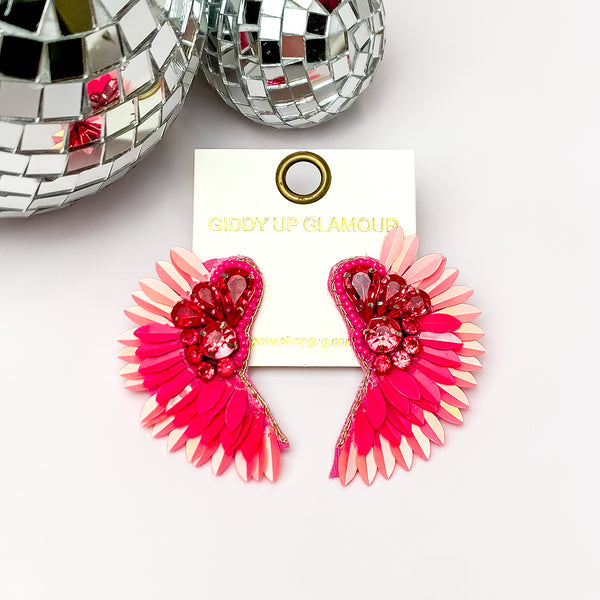 Saw An Angel Sequin Earrings with Clear Crystals in Pink. Pictured on a white background with disco balls in the top left.