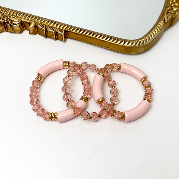 Set of Three | Sunny Bliss Crystal Beaded Bracelet Set in Light Pink. Pictured on a white background with a gold frame mirror at the top.