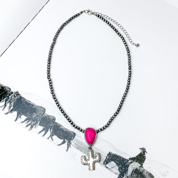 Cactus Queen Faux Navajo Silver Tone Necklace with Stone in Pink. Pictured on a white background with a picture behind it.