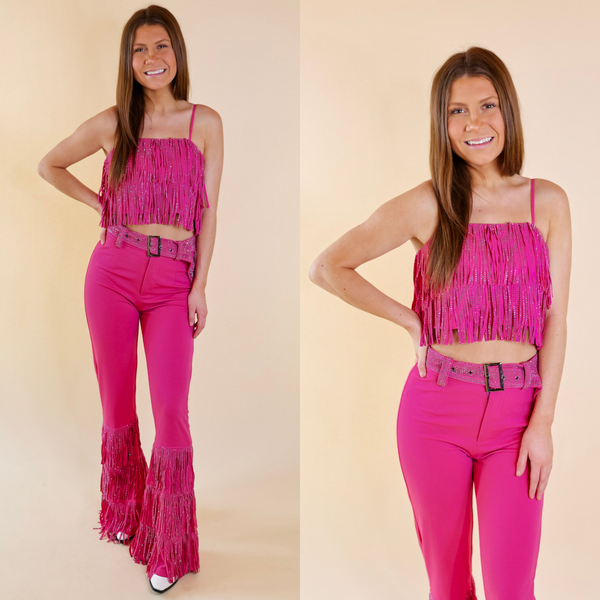 Model is wearing a pink crystal fringe tank top with a matching pink crystal fringe skirt. Model has it paired with white booties, a white hat, and silver jewelry.