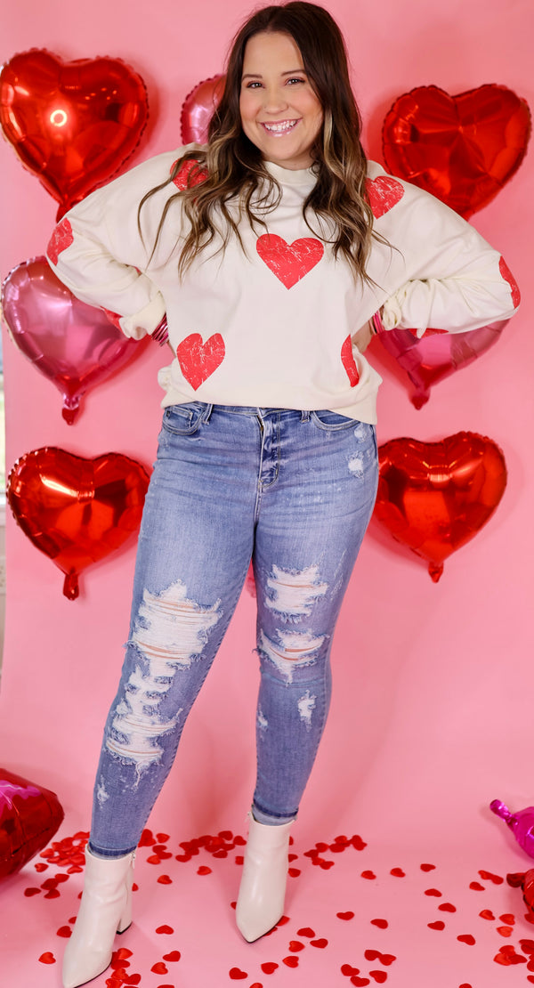 Hearts and Kisses Long Sleeve Pullover Sweatshirt with Distressed Hearts in Ivory