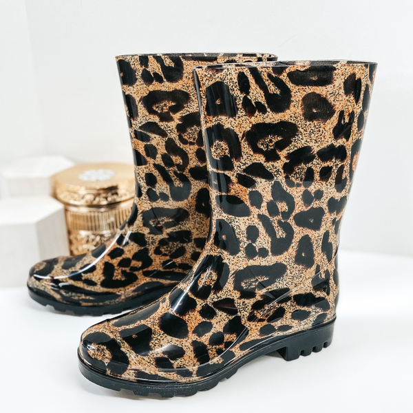 Leopard print  mid-calf rubber boots. Pictured on white background.