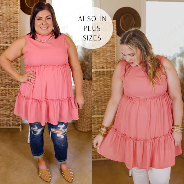 Model is wearing a high neck tank tunic top in coral pink. Model has this paired with skinny jeans, nude mules and gold jewelry.