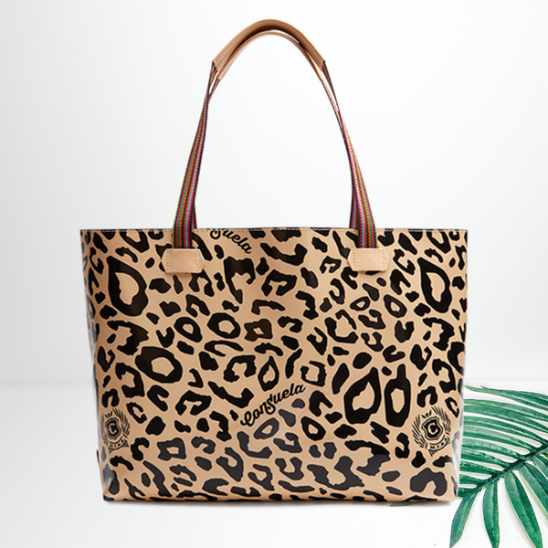 Centered in the picture is a tote bag in tan cheetah. To the right of the tote is a palm left, all on a white background.