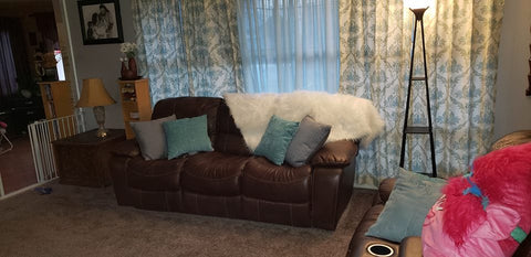 Luca Fur Throw and colorful decorative pillows in a living room