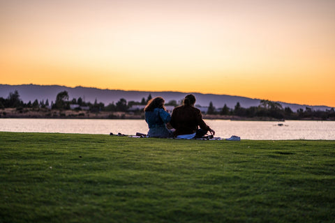 Two people watching the sunset at the park | The Smile Blog | TheWhiteningStore.com