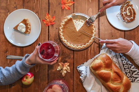 people's hands over Thanksgiving meal | The Smile Blog | TheWhiteningStore.com