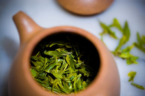 green tea in a brown teapot