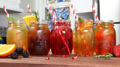 iced fruit tea in jugs with straws