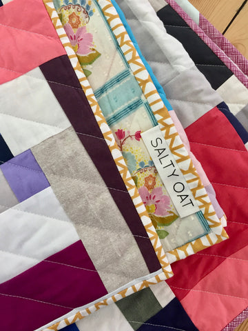 solid improv throw quilt by salty oat