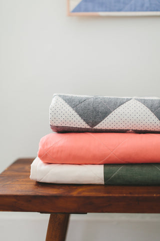 Stack of Folded Quilts by Salty Oat