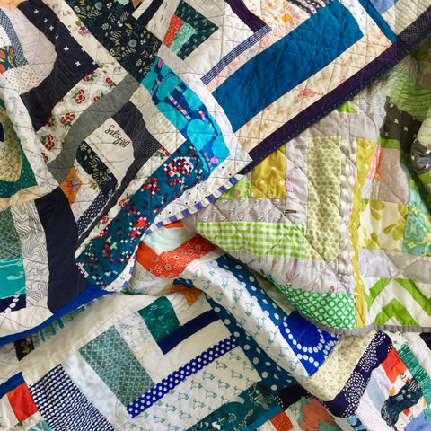 pile of quilts by the modern quilt collective