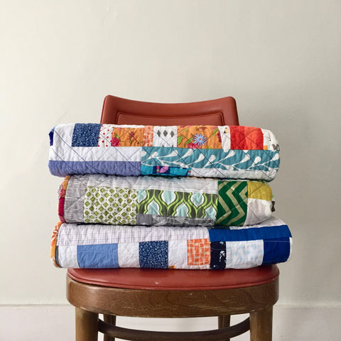 stack of quilts by the modern quilt collective