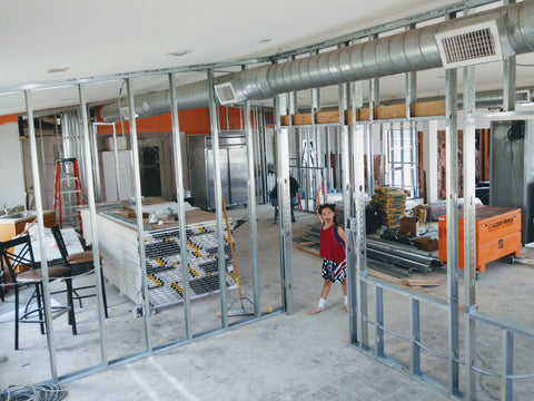 Walls going up with the help of the co-owner's daughter during the renovations of Trianon Coffee in summer 2018