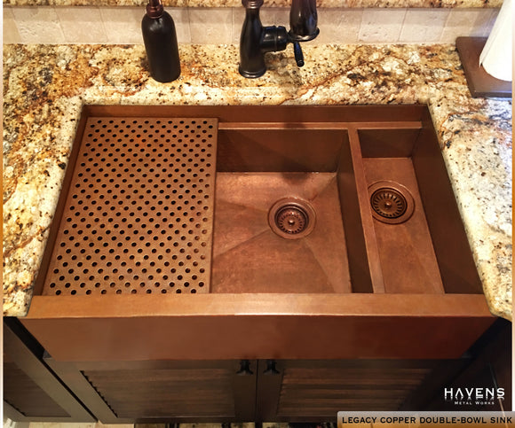 Double bowl copper farmhouse sink with a built-in ledge for advanced ergonomics in the kitchen. Custom made by Havens.