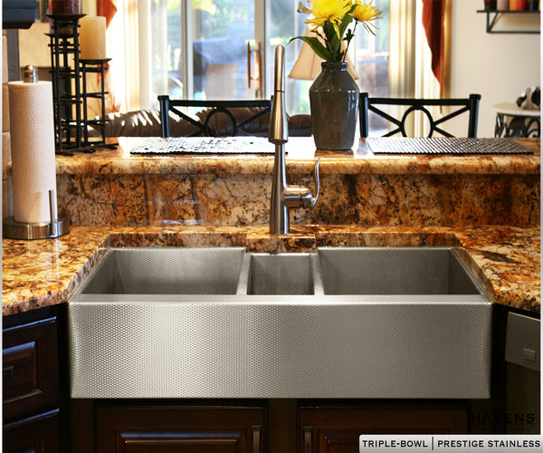 Custom triple bowl stainless steel undermount sink by Havens, shown here with the beautiful farmhouse apron front.