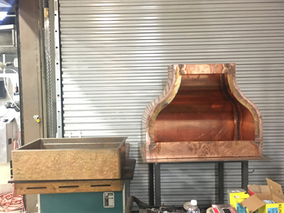 Custom copper range hood and hammered copper sink combination