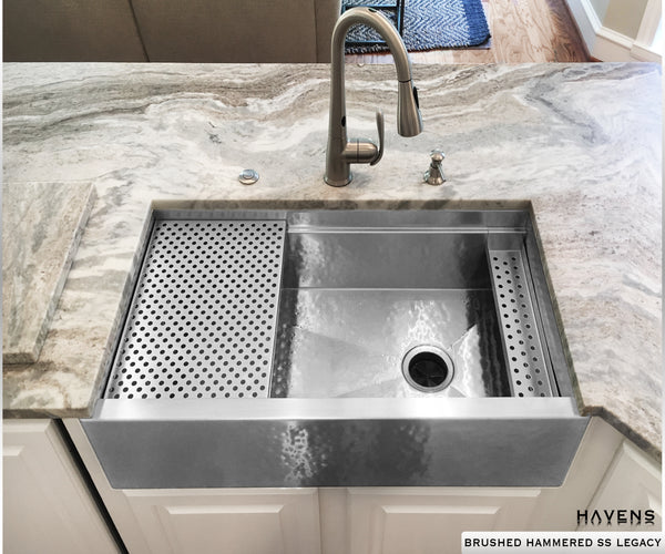 Hammered stainless steel farm sink with right rear drain and built in ledge for accessories.