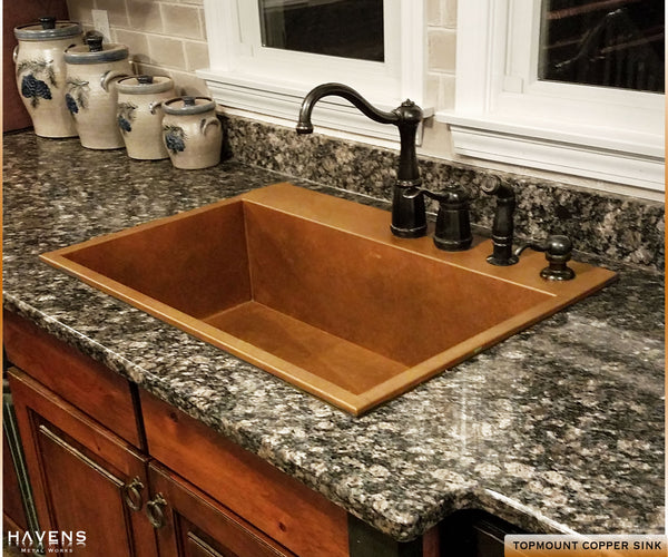 Top mount Heritage copper sink with a rear deck for faucets.