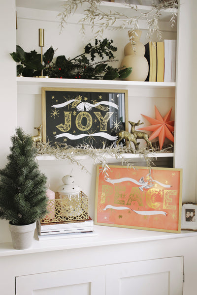Christmas decor:  prints displayed on a bookshelf