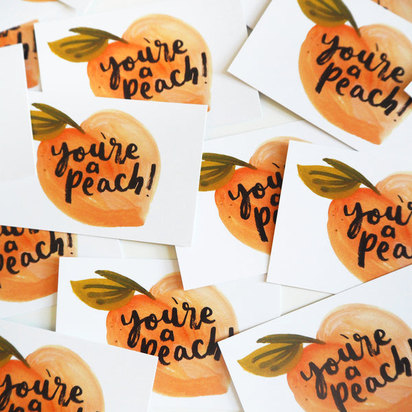 a pile of "you're a peach" business cards