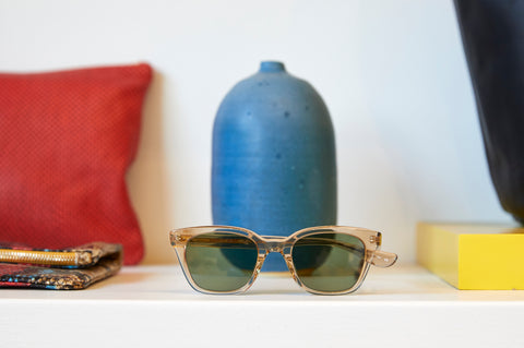Clare v. x Garrett Leight Sunglasses in Clear Sitting in Front of A Vase