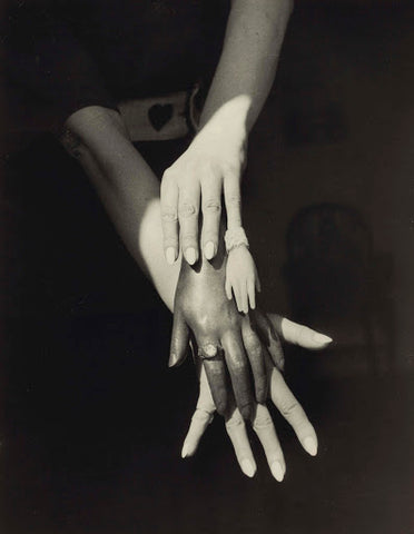 Black and white surrealist photo by Claude Cahun of various sizes of white and black hands layered on top of eachother