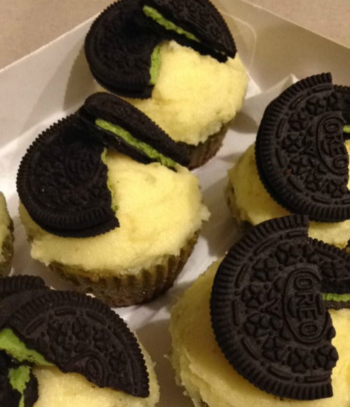 Buttercream frosting matcha cupcakes topped with matcha green tea oreos