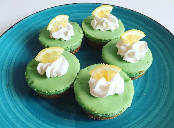 Sweet delicious Mini Matcha Cheesecake topped with light whipping cream and lemon slice topping