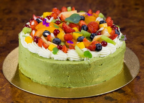 Green Tea Matcha Fruit Cake recipe with green tea fluffy light cake coated with creamy luscious matcha cream and topped with mixed fresh fruits, kiwi, strawberries, blueberries, mangos and cheries