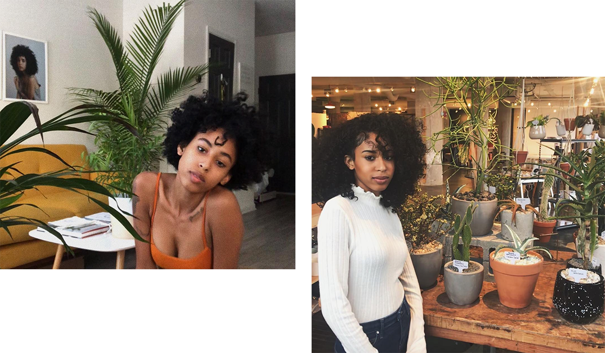 Woman with curly hair pictured with plants.