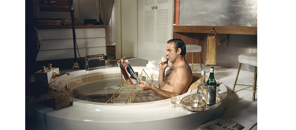 Man taking a bath while on the phone. 