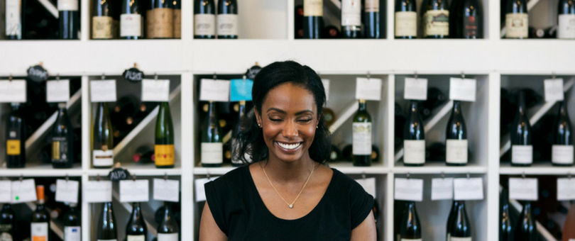 Retail loyalty program, woman in liquor store | Shopify Retail blog