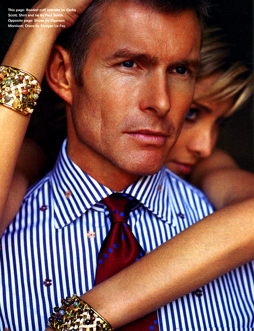male model with female model hugging him - she wears two Darby Scott signature wicker cuff bracelet set with a confetti array of colored semi-preciaous stones