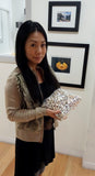 Hisano holding 3.4 kilos of metallic soufflé pearls