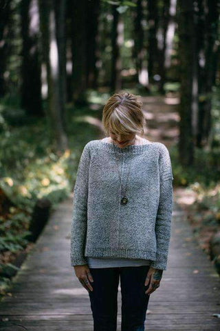 Photo of a woman wearing a light blue knit sweater, the Weekender Sweater by Andrea Mowry