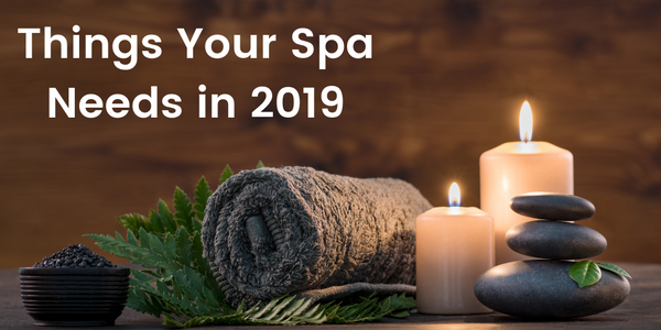 spa towels with candles and hot stones