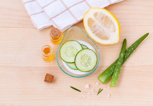 Natural Toner: Cucumbers, lemon, aloe, and jar of liquid on a table