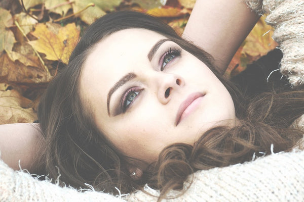 Natural Toner: Brunette girl laying in a pile of leaves