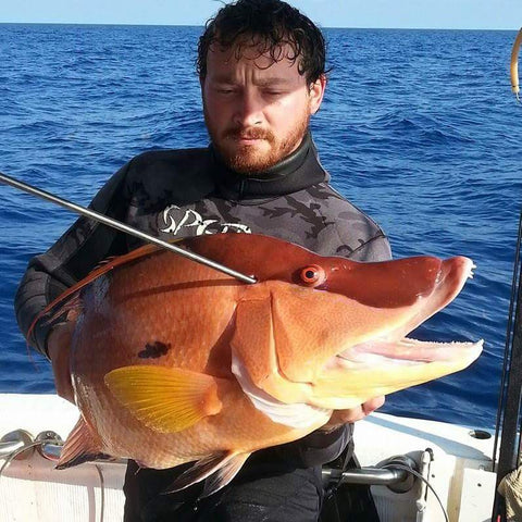 Fisherman DJ Skelton Posing with Fish on Boat After Spearfishing