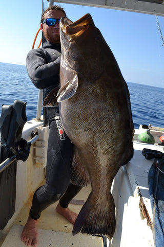 DJ Skelton Holding Huge Grouper on Boat in Gulf of Mexico
