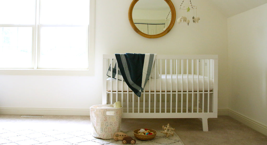 navy gingham quilt in baby boy nursery