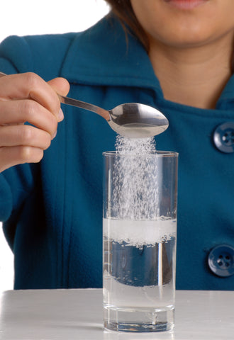 Woman mixing salt with water