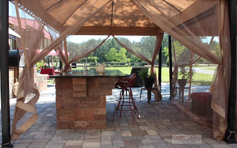 Gazebo covering an outdoor kitchen island and patio furniture