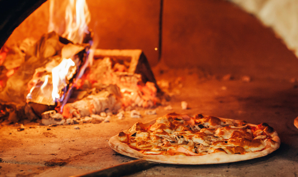 Pizza on a peel in a wood fired oven