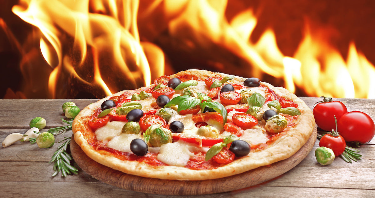 Vegetable Pizza Cooking In Front of Fire