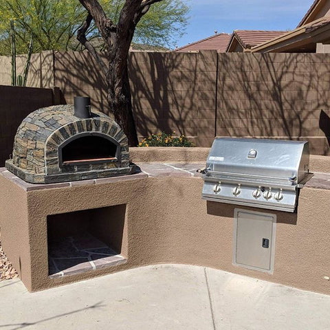 Pizzaioli brick oven with stone finish in outdoor kitchen