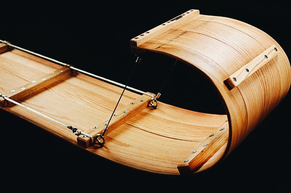 Against a black background: front curl of a downhill toboggan sled