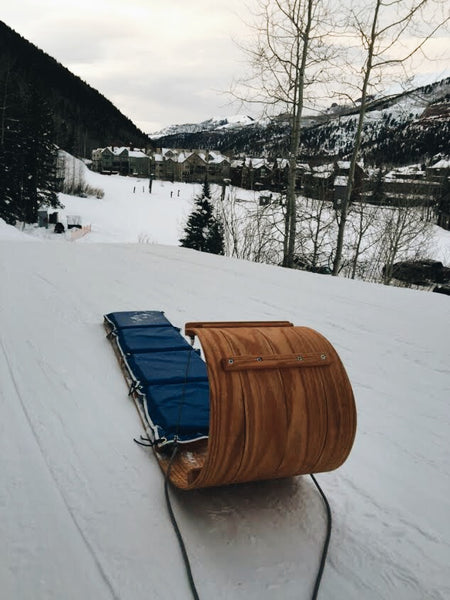 Downhill 'boggin sled at the top of a hill overlooking snowy hills