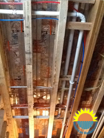 Staple-up radiant heating system installed with aluminium plates.